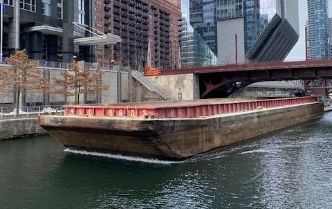 Large vessel on Chicago River being used to move aggregates in the city.